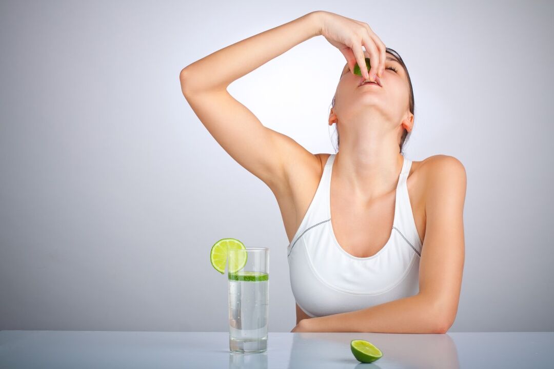 Mergina geria vandenį su citrina, norėdama numesti svorio